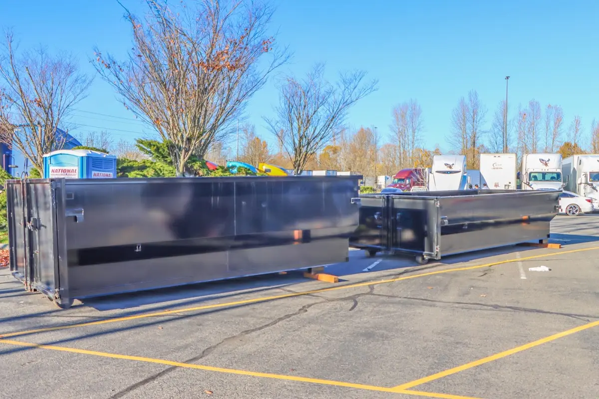 Professional dumpster rental service with roll-off container on residential driveway in Beaumont